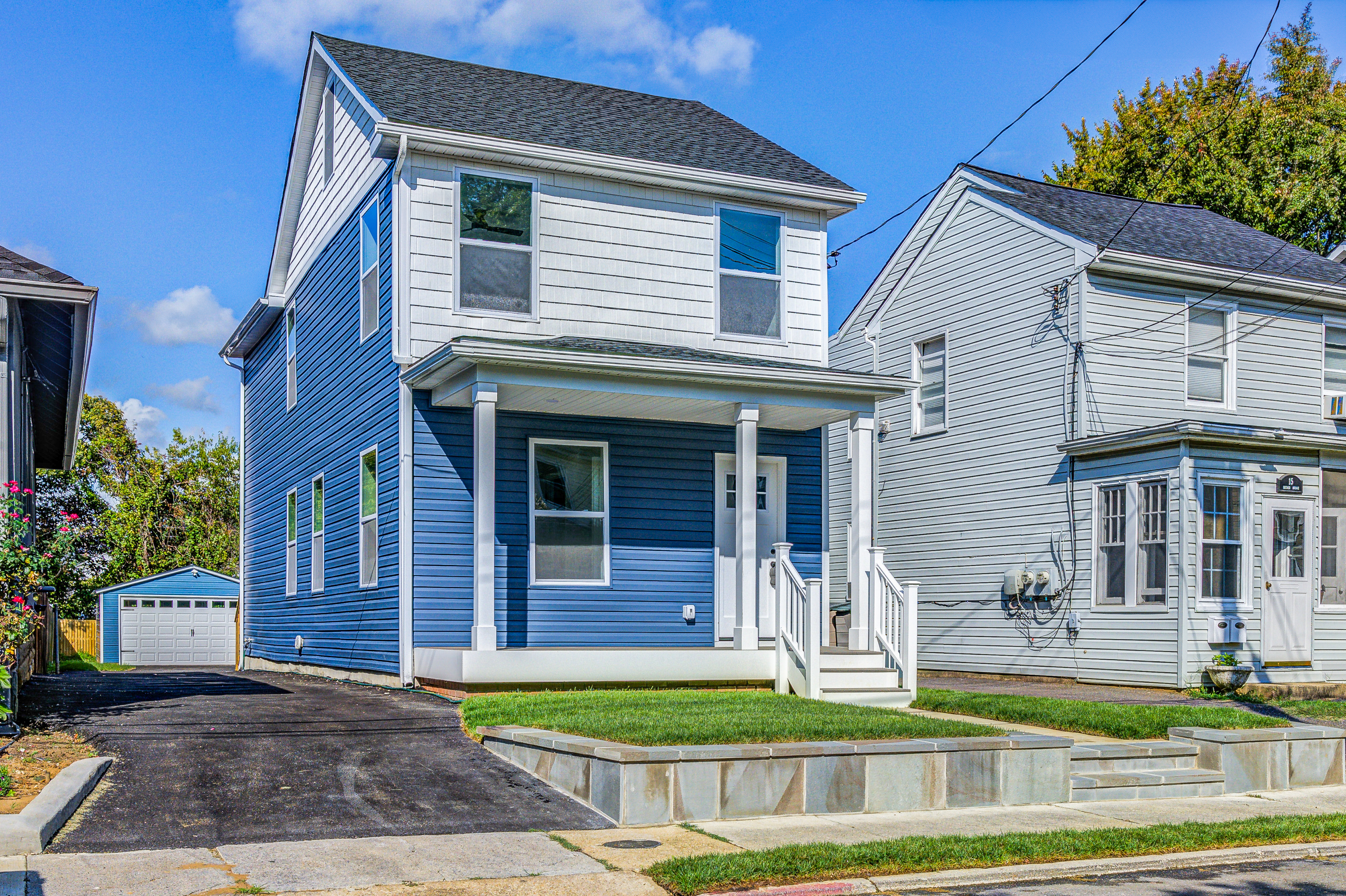 Blue siding and front porch white white columns and upper white cedar accent wall