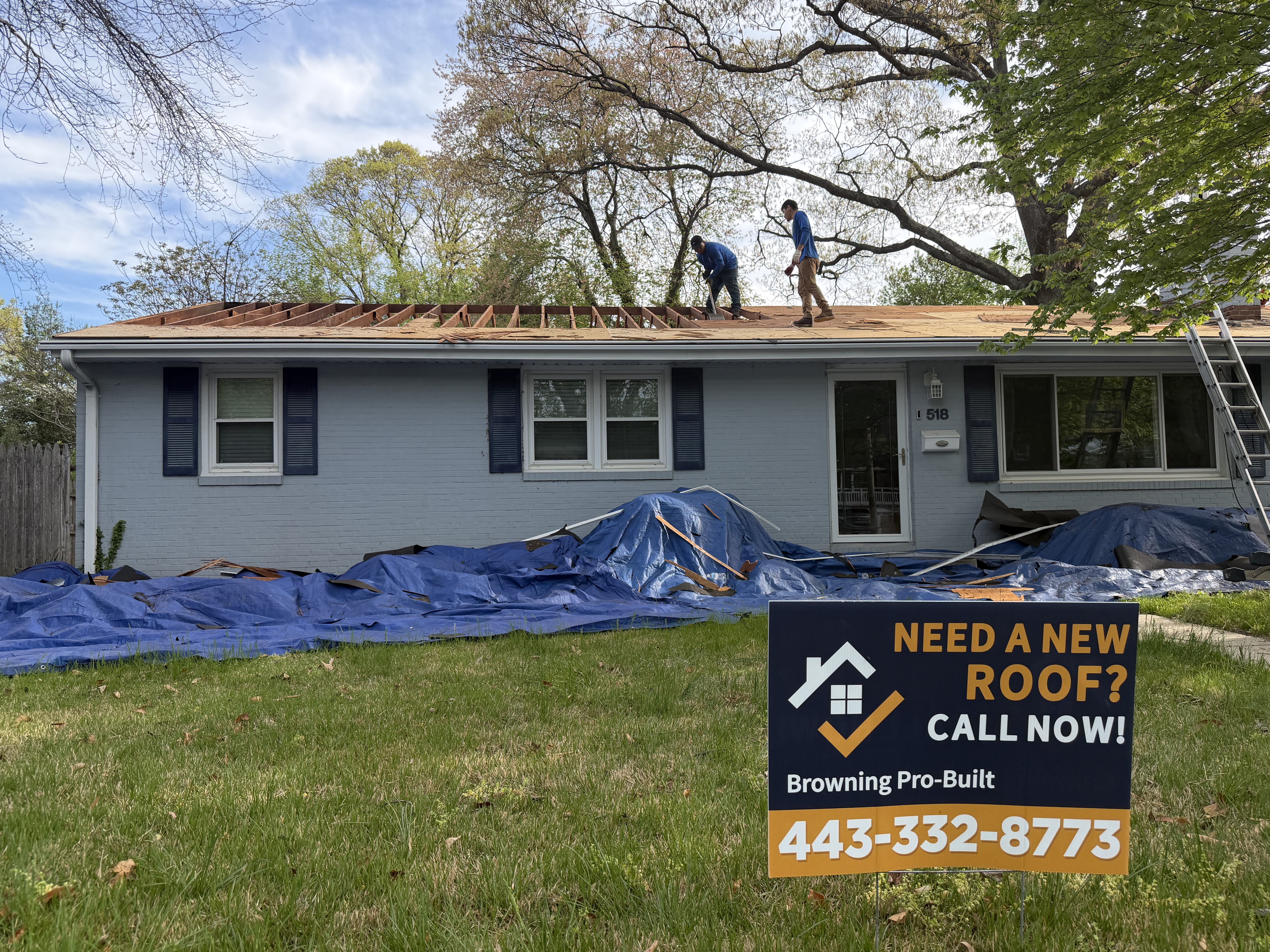 House with roof removed and yard sign out front