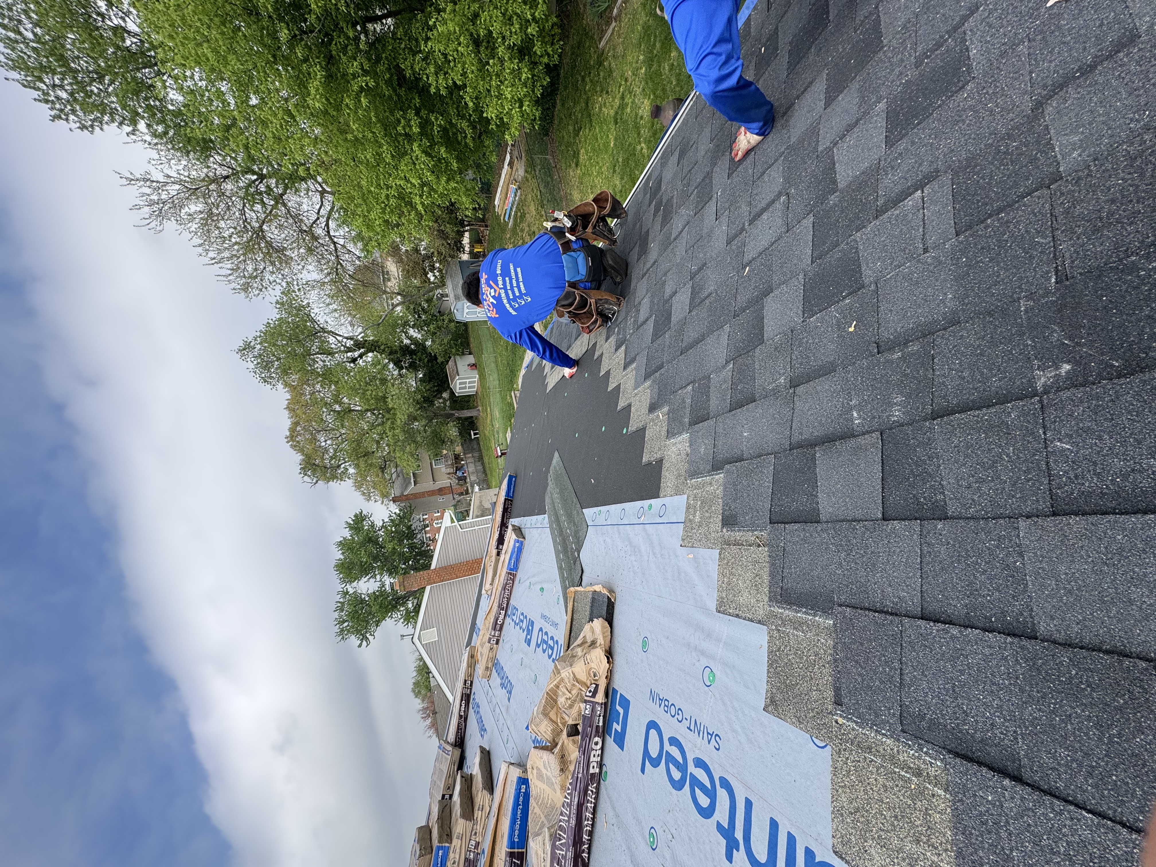Guys installing shingles on a roof